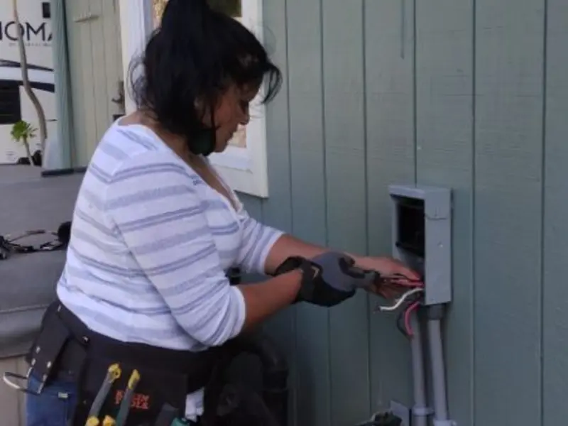 Licensed electrician wiring an exterior subpanel in Stoneham